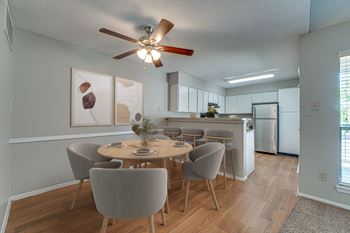 A dining room with a table set for four.